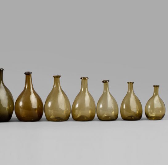 An Exceptional Set of 13 Graduated Blown Chestnut Bottles